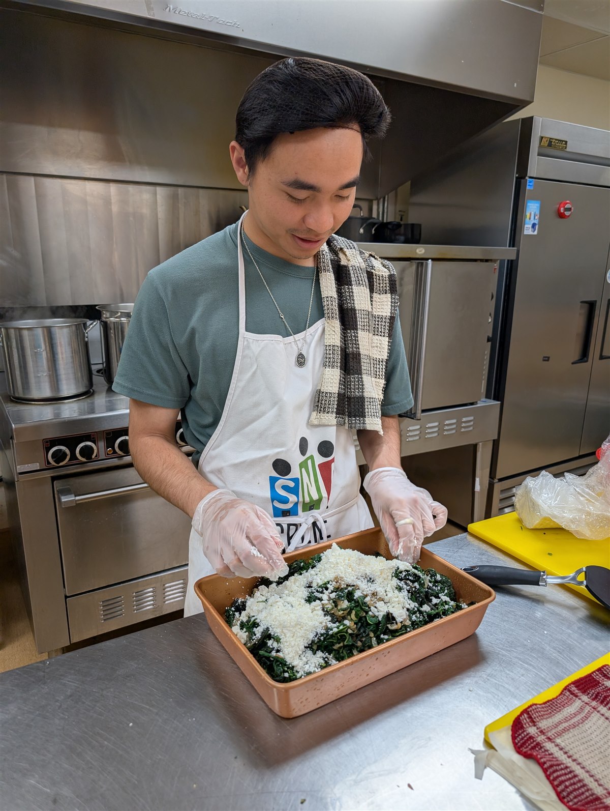 Kiran chopping ingredients on a cutting board.