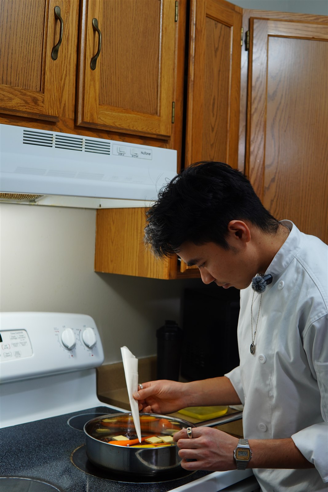 Kiran cooking in a white chef coat.